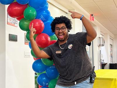 escited student pointing to balloons